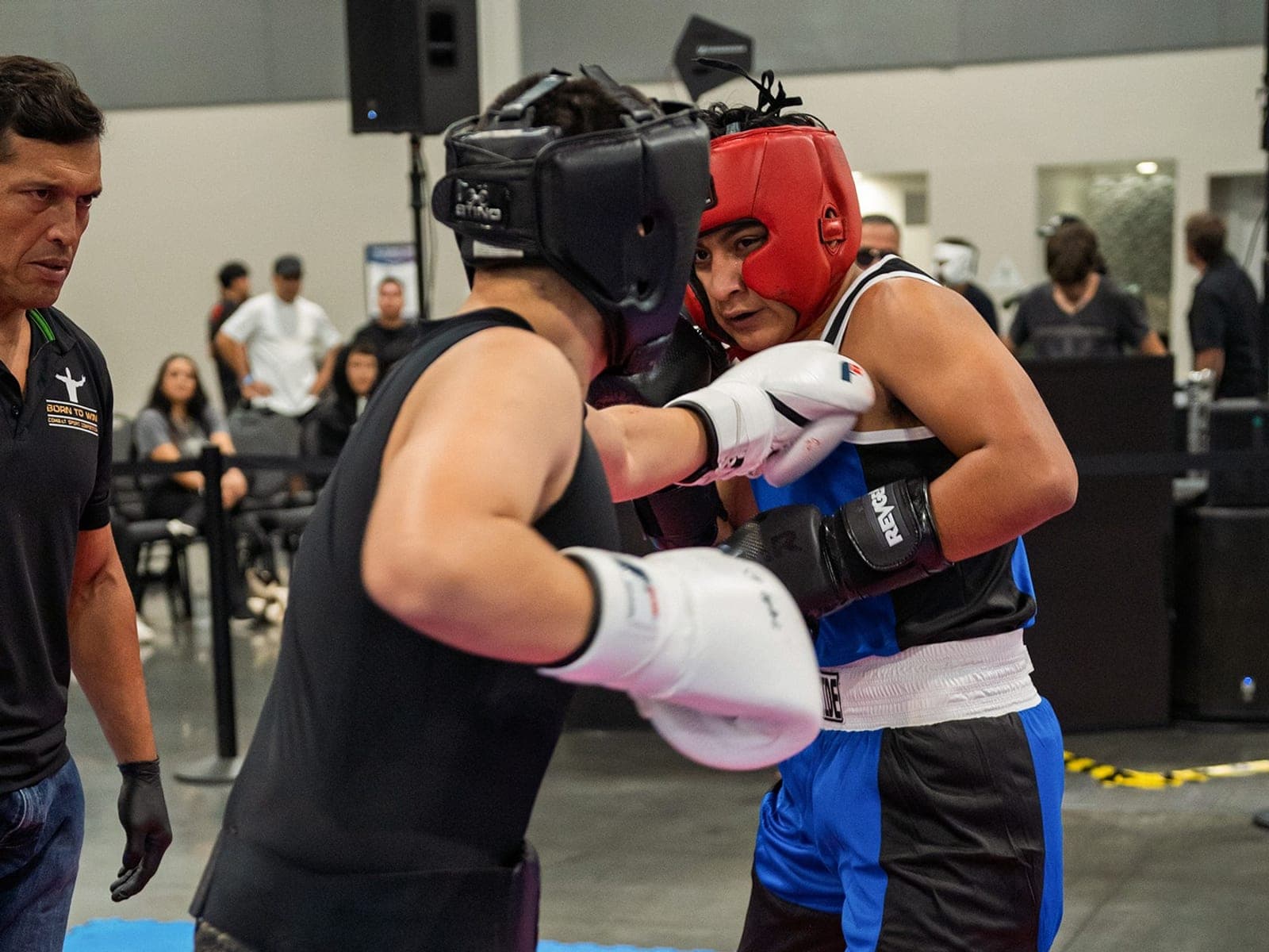 Two athletes closing the distance under an official's eye
